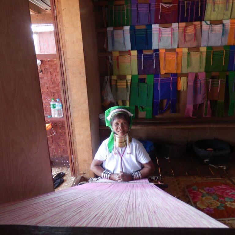 אשה משבט ארוכות הצוואר אורגת שטיח בעיירה באגם אינלה